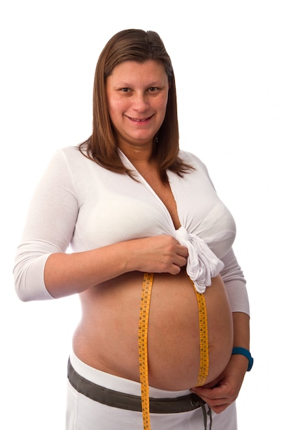 Pregnant woman misure her belly