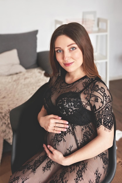 Pregnant woman in nursery Preparation for childbirth Babies wear and accessories