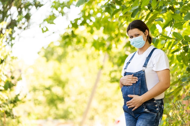 pregnant woman in a protective mask