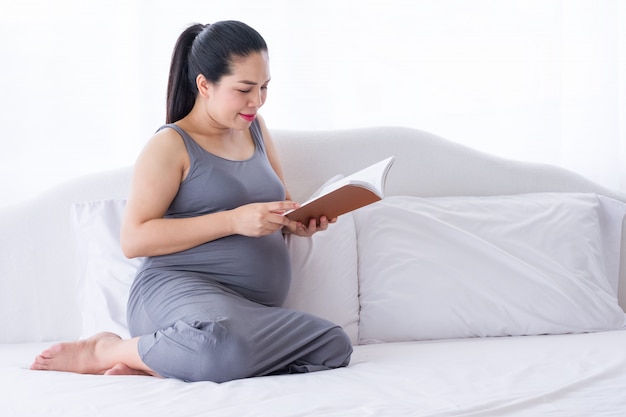 Pregnant woman reading a book.