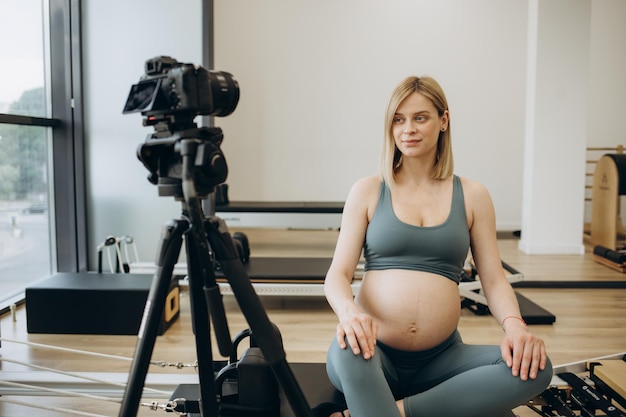 Pregnant woman recording video for blog and vlog