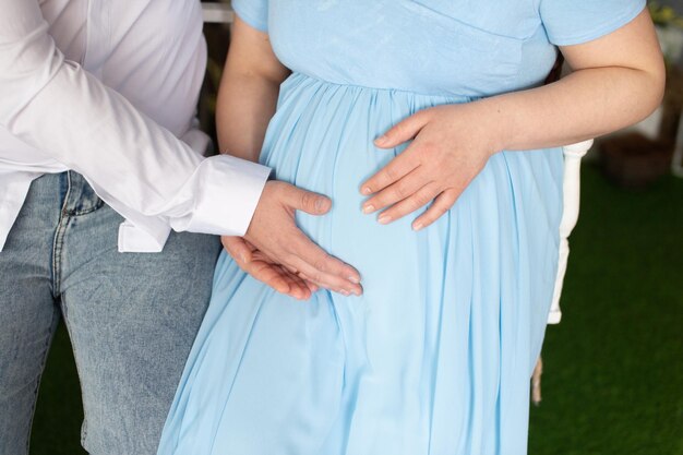 Photo a pregnant woman's stomach is held by male hands