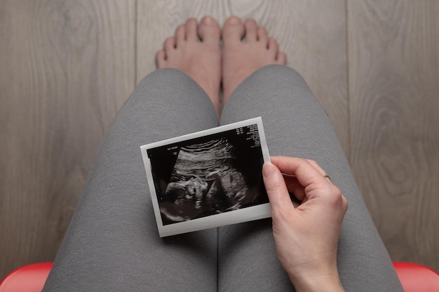 Pregnant woman sitting on chair top view