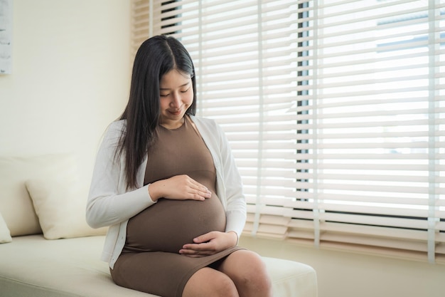 Pregnant woman sitting near the window at hospital