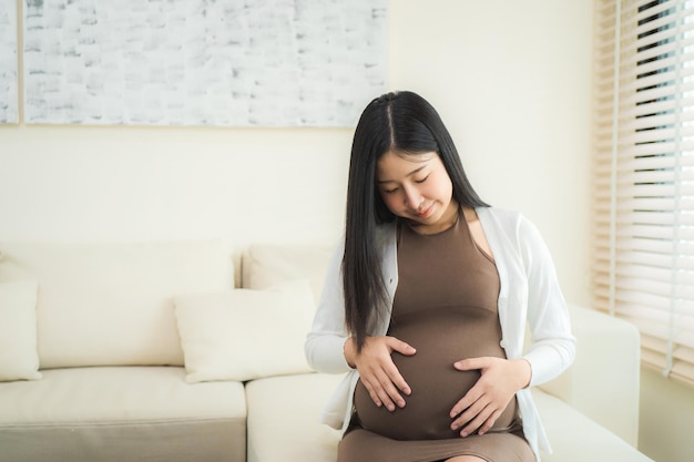 Pregnant woman sitting near the window at hospital