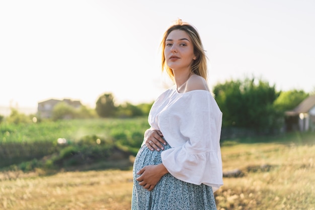 Pregnant woman standing in the field