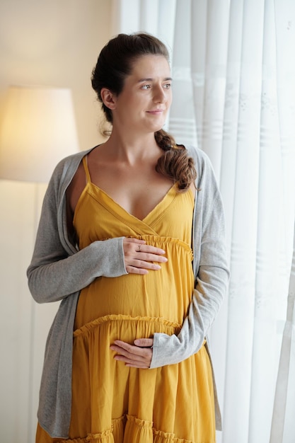 Pregnant woman standing at home