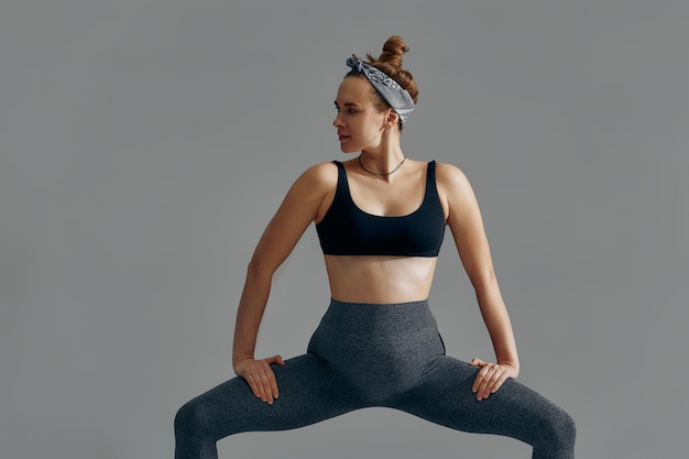 Pregnant Woman Stretching Arms And Legs Doing Prenatal Workout At Home On Yoga Mat Selective focus