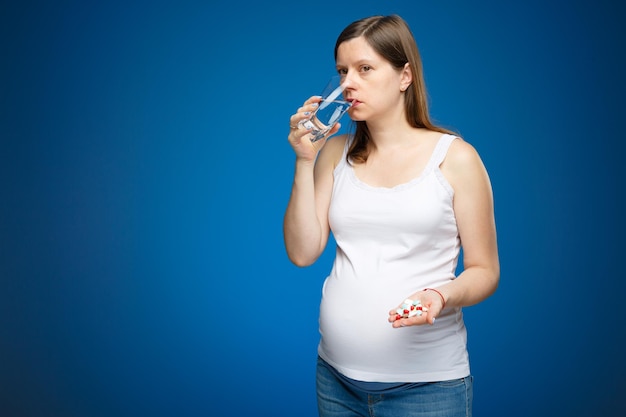 Pregnant woman taking pills for her baby to born healthy Special medical treatment for pregnant