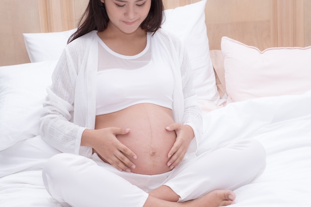 Pregnant woman touch her belly