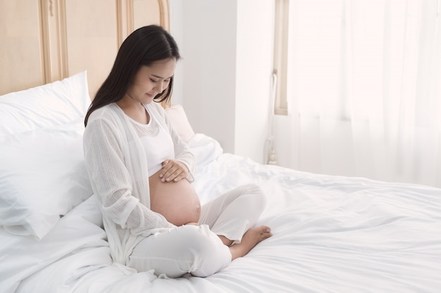 Pregnant woman touch her belly