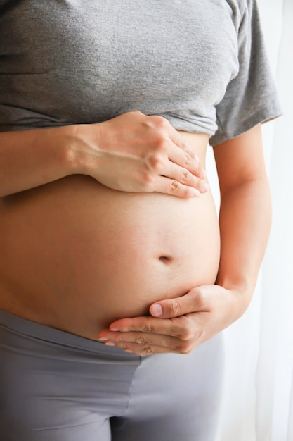 Pregnant woman touching belly