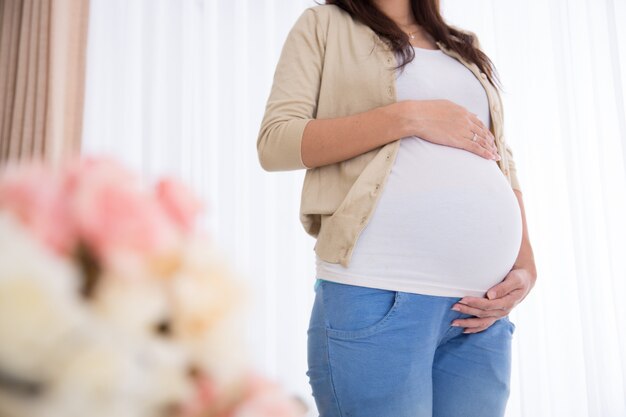 Pregnant woman touching her belly