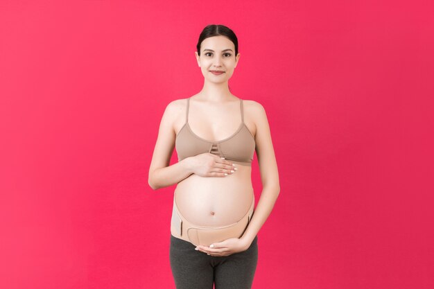 Pregnant woman using an abdominal belt