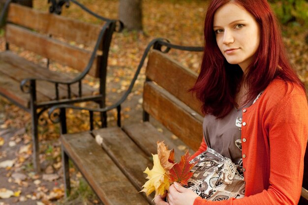 Pregnant woman walking in autumn park