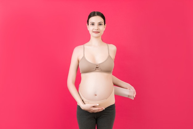 Pregnant woman wearing support belt on her belly