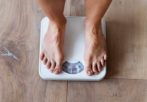 Pregnant woman weighing herself