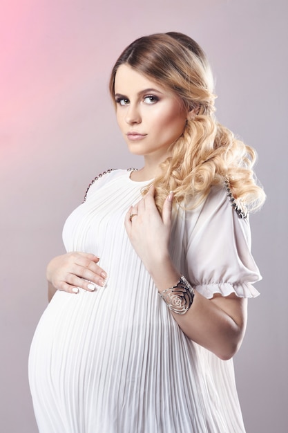 Pregnant woman in white dress birth of the child