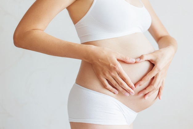 Pregnant woman in white underwear