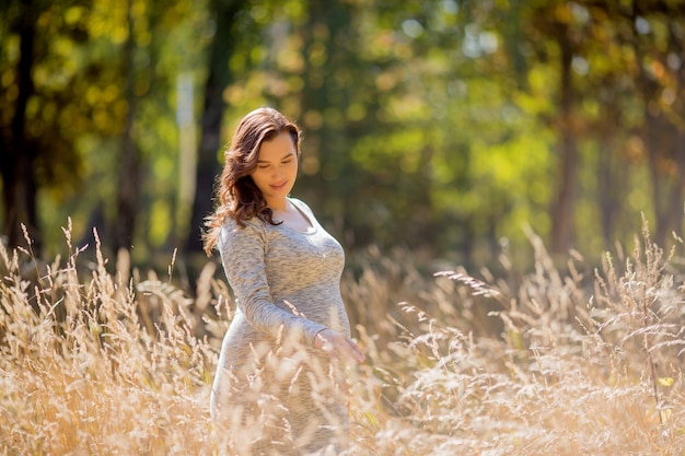 pregnant woman with dress posing in nature