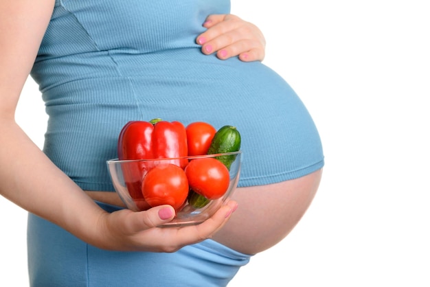 Pregnant woman with fresh vegetables