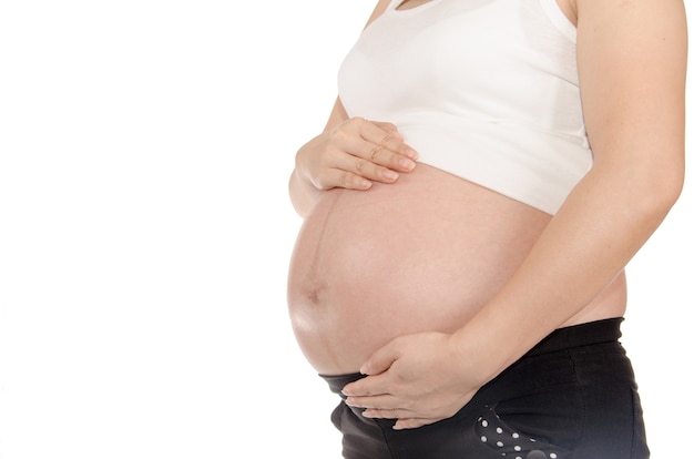 pregnant woman with gentleness and love touching her belly