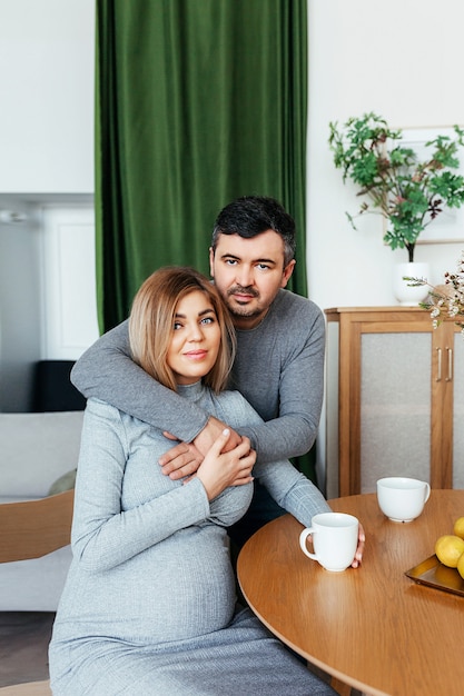 Pregnant woman with her husband at home