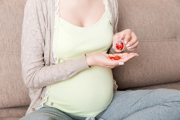 Pregnant woman with pills in hand healthcare concept medicine during pregnancy