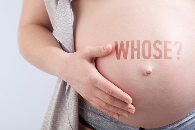 Pregnant woman with title whose on her belly