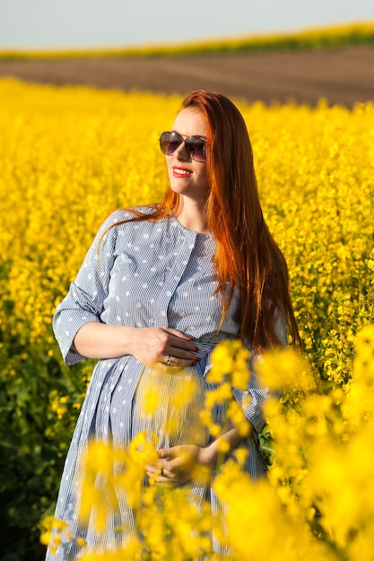 Pregnant woman in yellow field