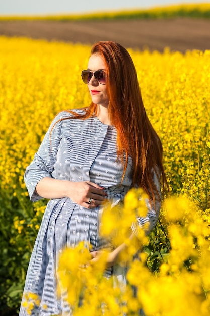 Pregnant woman in yellow field