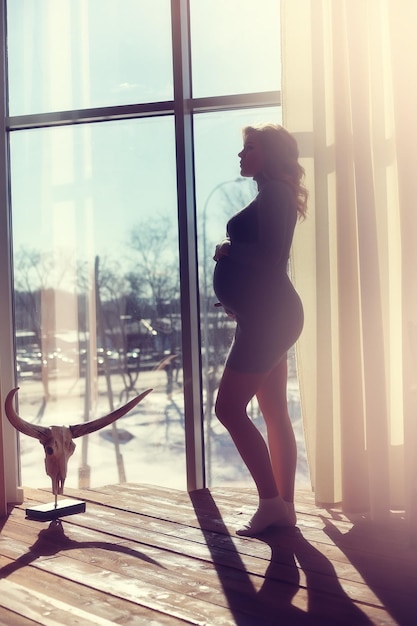 Pregnant young and beautiful girl in a vintage home