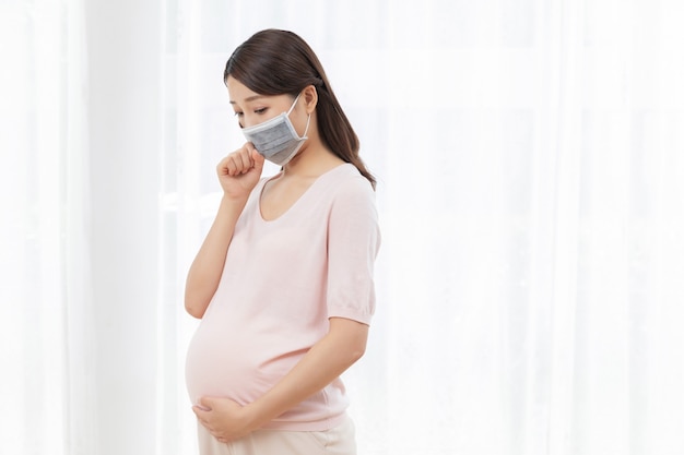 Pregnant young woman with a mask