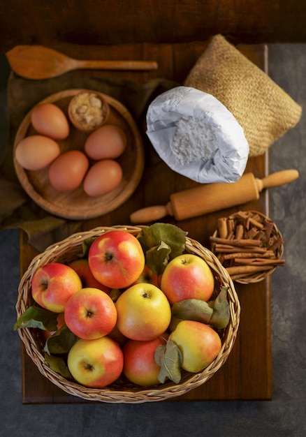 Preparation to bake an apple pie on a wooden table