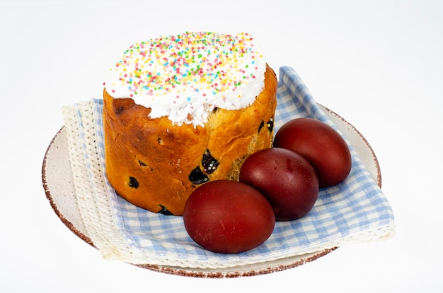 Preparation for celebration of Easter. Homemade cake and red colored eggs. Studio Photo