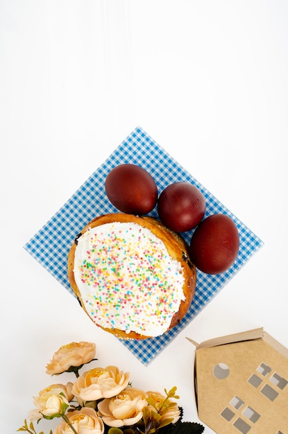 Preparation for celebration of Easter. Homemade cake and red colored eggs. Studio Photo