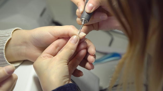 Preparation of a manicure in a beauty salon. Machining and grinding.