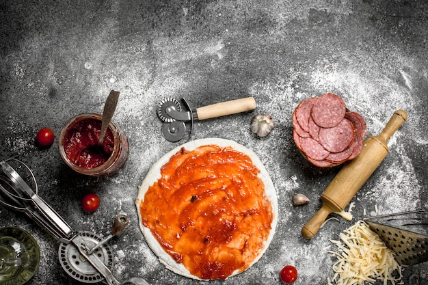 Preparation of pizza. On a rustic background.