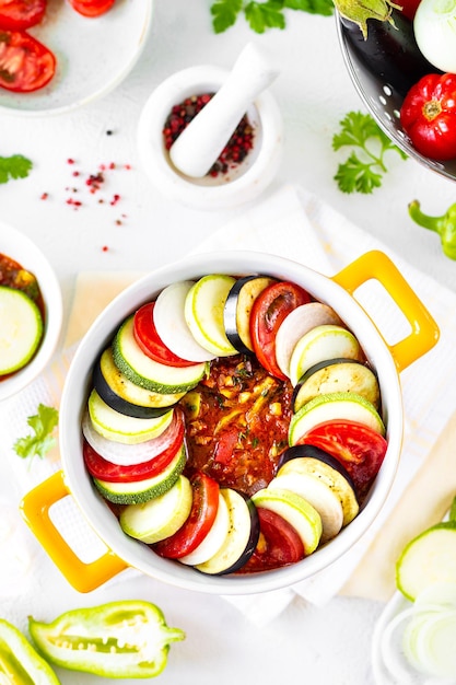 Preparation of ratatouille a traditional French provincial vegetable dish White background Top view