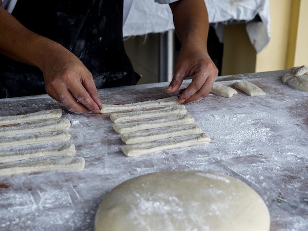 Preparation of raw materials for making deepfried dough sticks or Patongko with wheat flour before throw in boiling oil to fry Asian famous street food in Thailand Chinese doughnuts style