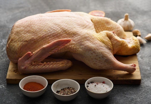 Preparation Raw whole duck or goose Duck with apples and spices on a wooden board