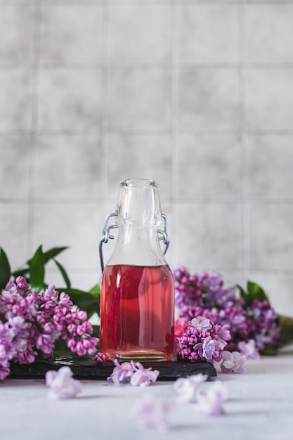 Preparation of syrup from the lilac flowers Glass jar of homemade lilac syrup