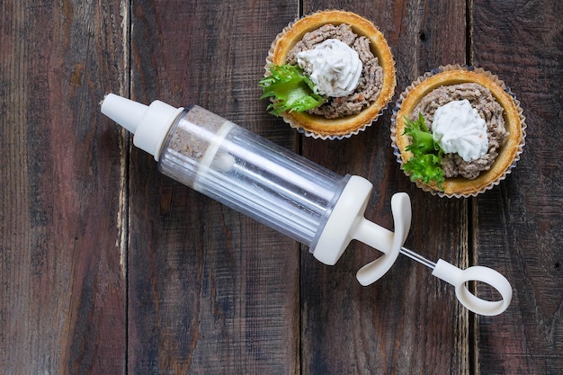 Preparation tartlets with liver paste ricotta and lettuce