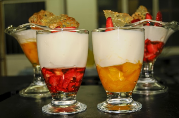 Preparation of yogurt and fruit mousse in glass cups