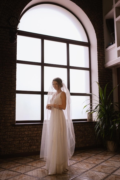 Preparations for the bride with the dressing of the wedding dress