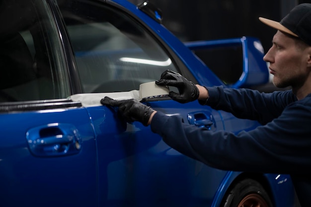 Prepare for a car polish applying tape to protect some parts