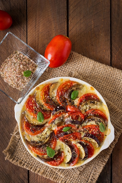 Prepared gratin dish raw eggplant with mozzarella and tomatoes