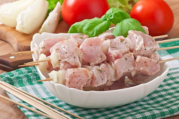 Prepared marinated with onions and herbs pieces of meat for barbecue