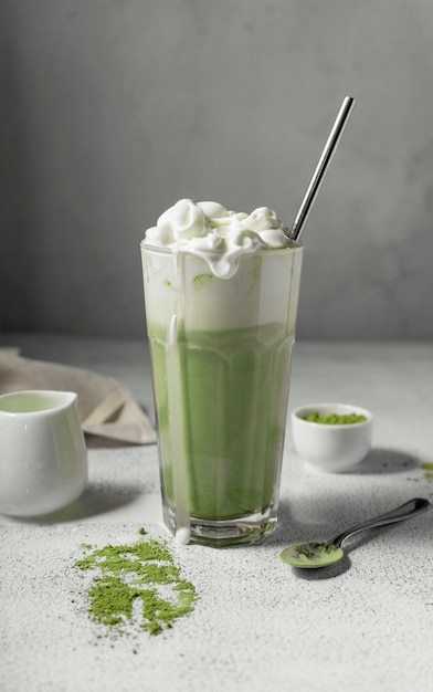 prepared matcha tea in a clear glass. a delicious drink made from Japanese green tea powder. vertical position