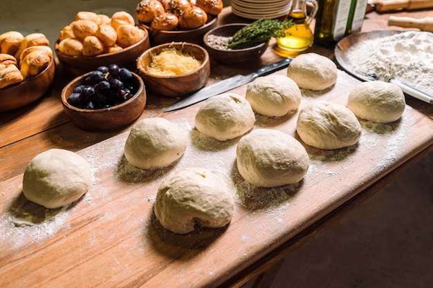 Preparing buns bread Rustic style Bread cooking process kneading dough on wooden platebun cooking